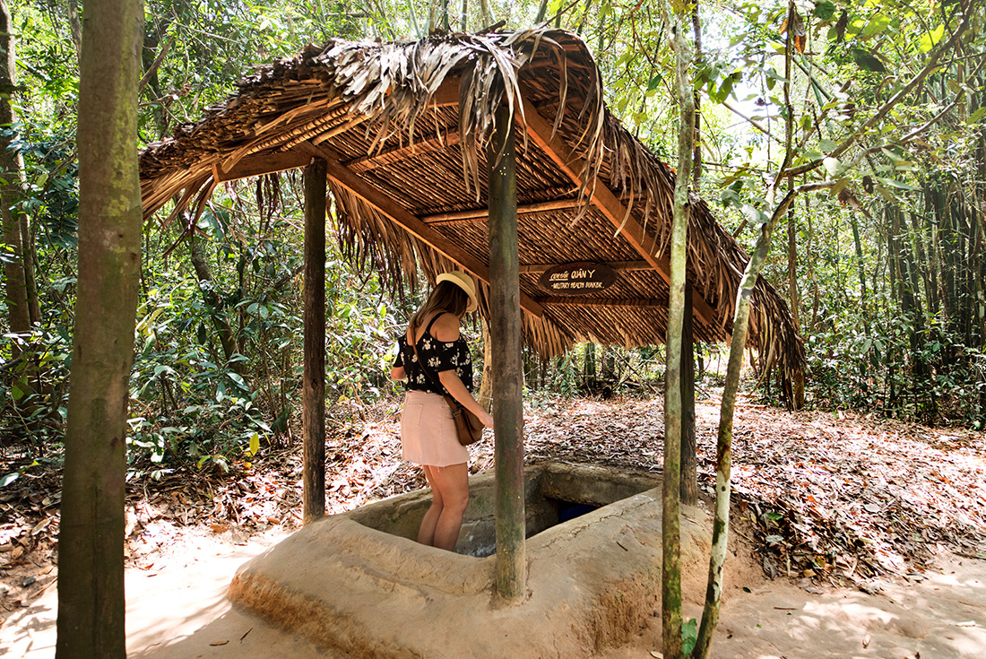 A traveller is descending the steps into an entrance to the famous Cu Chi Tunnels used during the war in Ho Chi Minh City, Vietnam.