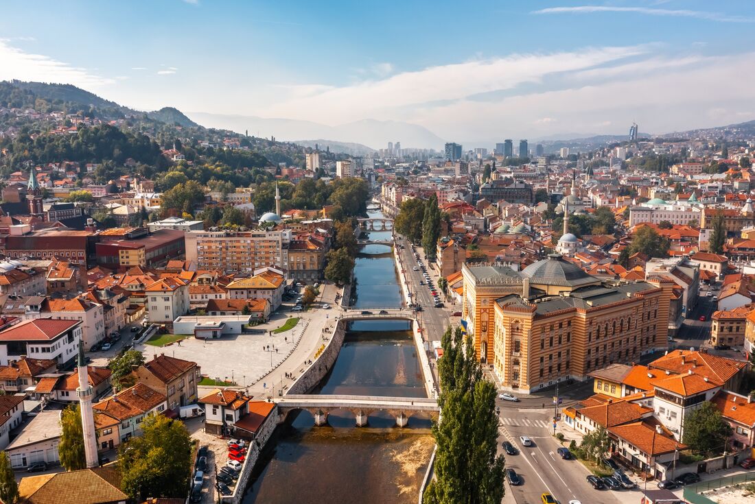 Looking at the township Sarajevo, Bosnia on a clear blue skied day, showing the river.