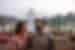 Two travellers laugh together standing in front of the Taj Mahal near Agra India