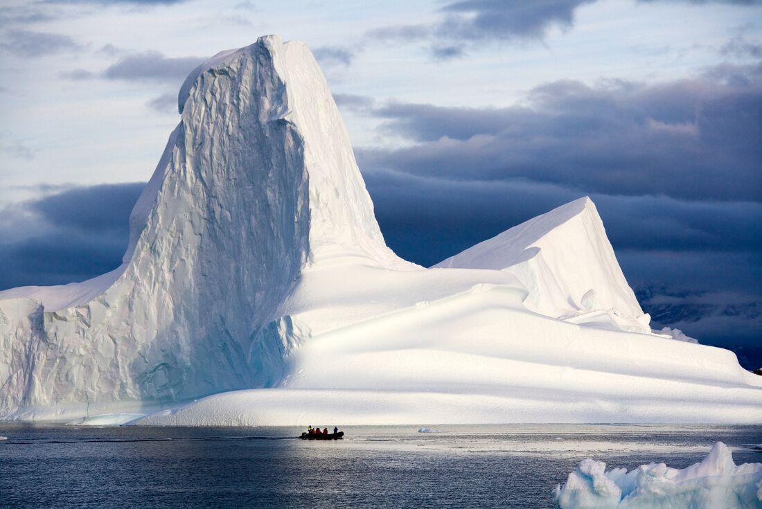 Get up close with one of the iconic Scoresbysund icebergs