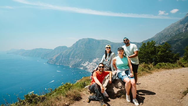 Intrepid group smiles as they pose along the Path of the Gods on the Amalfi Coast.