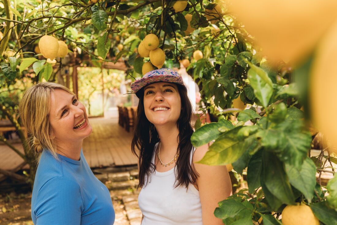 Travellers smiling while at a lemon grove on the Amalfi Coast in Italy