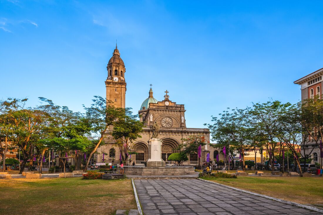 Manila Cathedral in Intramuros at sunset with curated trees downtown