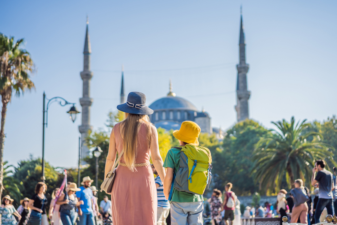 Intrepid traveller parent and child taking in the Blue Mosque in Istanbul, Turkiye