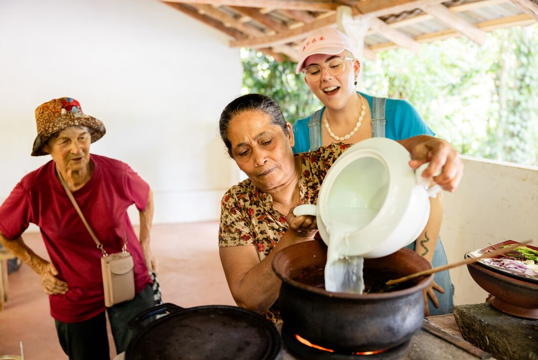 Travellers observing local cooking at Spice Garden Tour, Matale, Sri Lanka