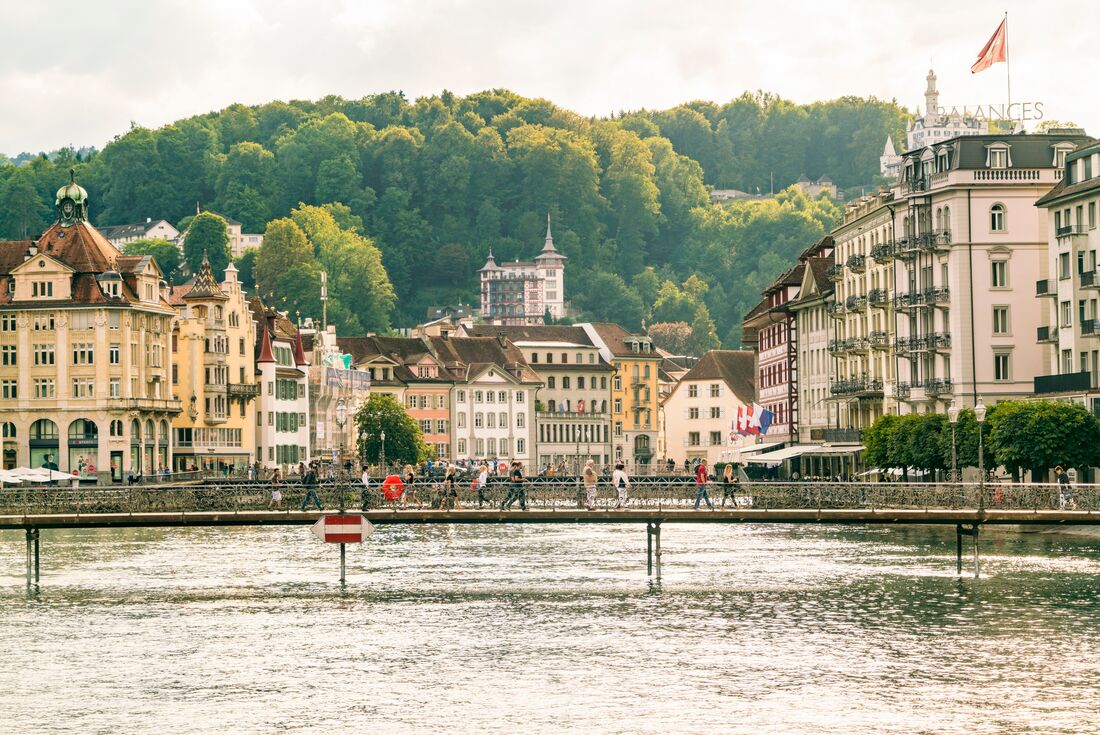 Wide shot of Intrepid travellers crossing the rivers of Lucerne in central Switzerland