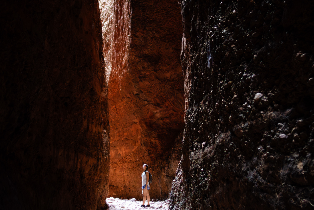 Younger Intrepid traveller looking up in the smooth curling walls of Echidna Chasm in the Kimberley