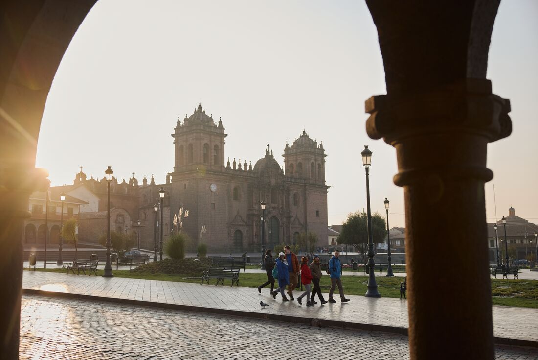 Intrepid travellers get familiar with Cusco walking through the Plaza de Armas in the early morning