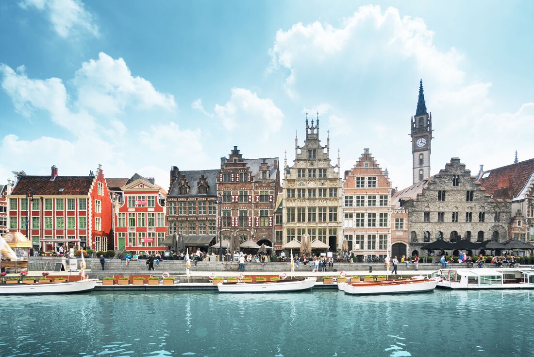 Boats lined up along the river in the old town of Ghent, Belgium