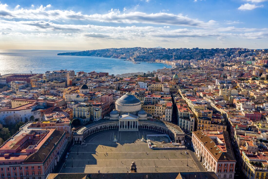Aerial view of the city of Naples wiith Piazza de Plebiscito in foreground and harbour beyond the city