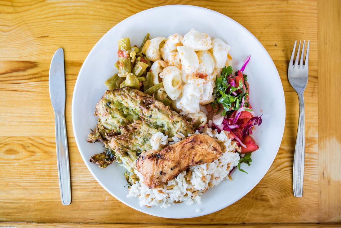 Plate of fresh healthy food with meat on a neat plate with wooden table