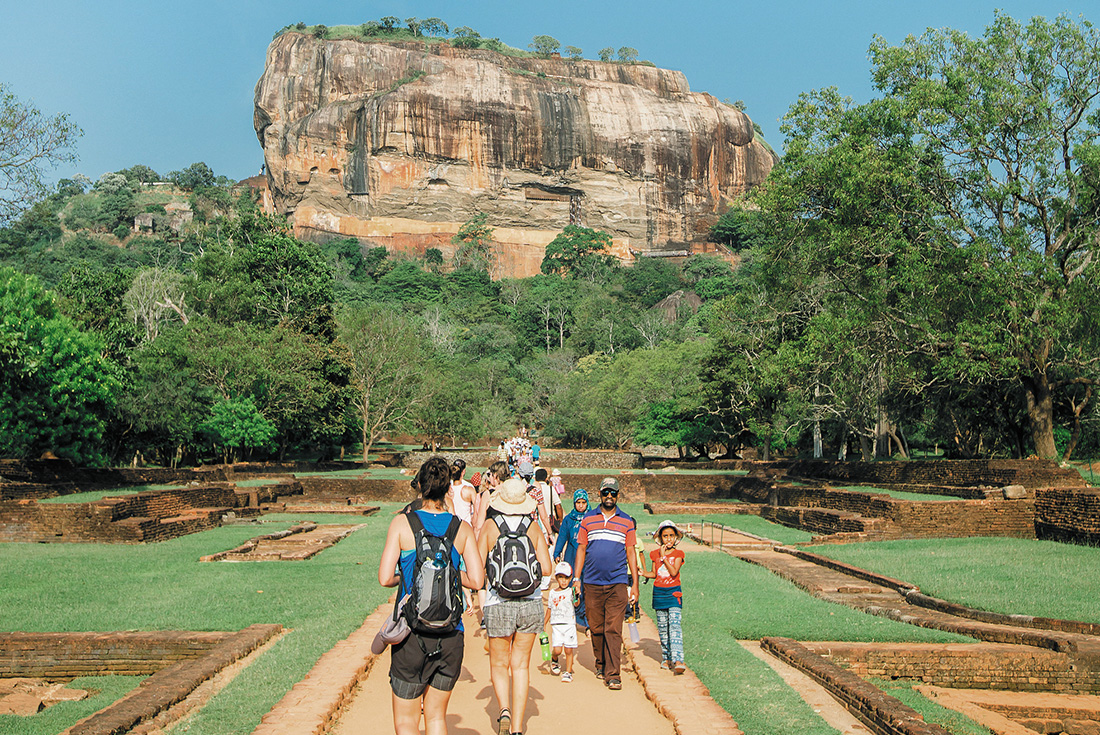 Intrepid travellers walking towards Sigiriya Rock to commence the climb in Sri Lanka