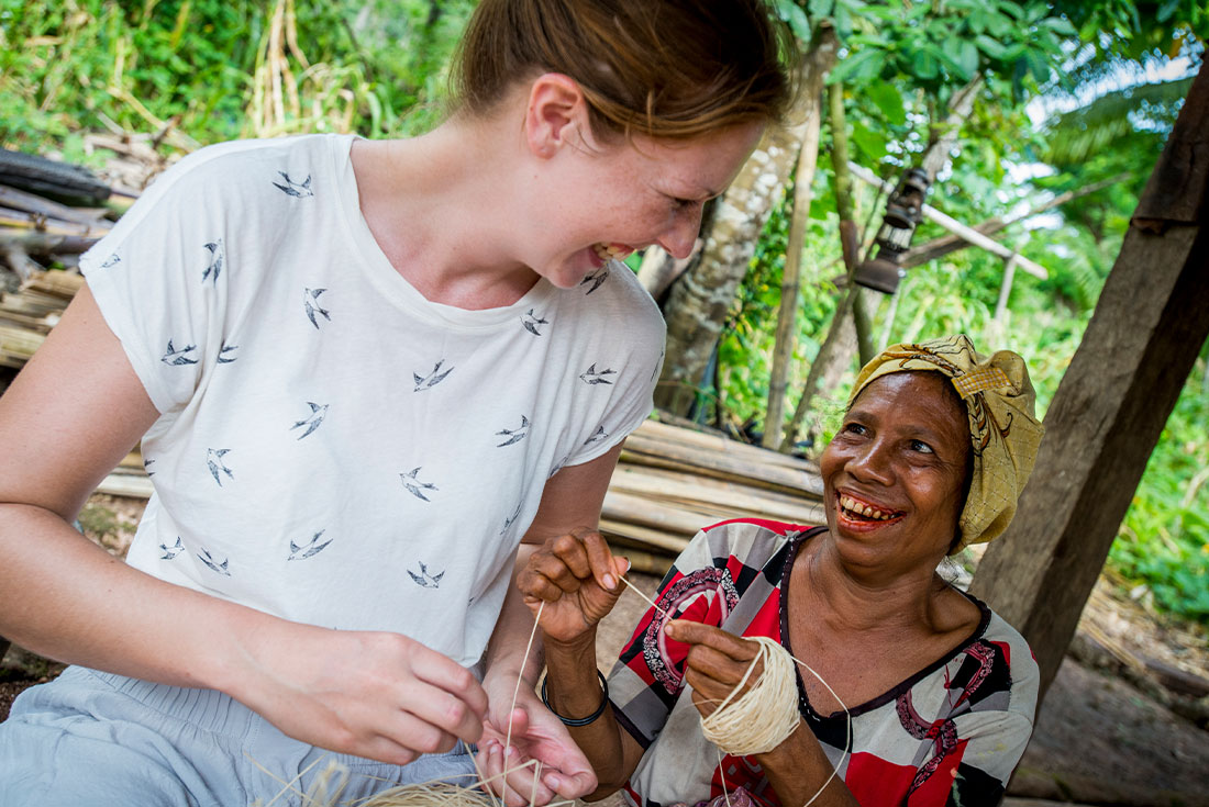 Traveller learning handicrafts from local, Timor-Leste
