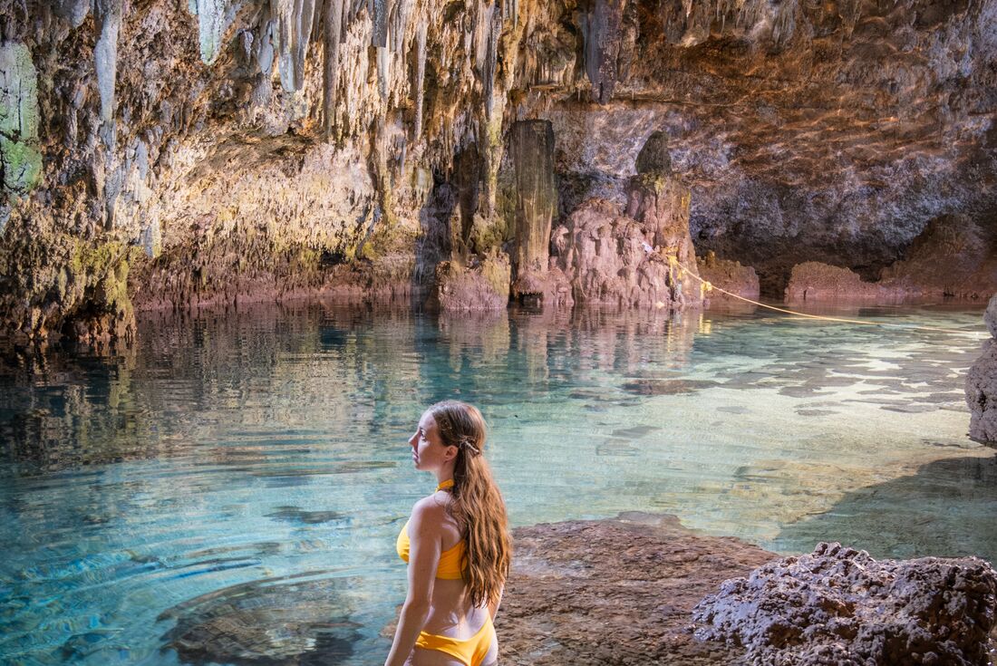 Traveller POV looking around a cenote in Choo-Ha cave, Coba, Mexico