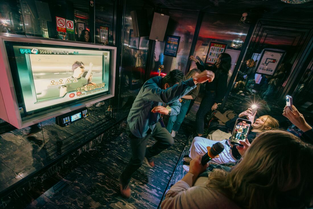 Leader Yong Park dances with group in Seoul during karaoke