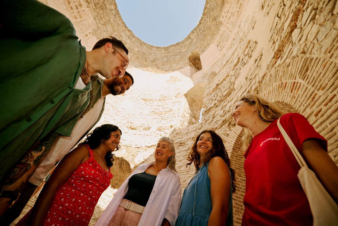 Upwards view of travellers and interior of Diocletian's Palace, Split, Croatia 