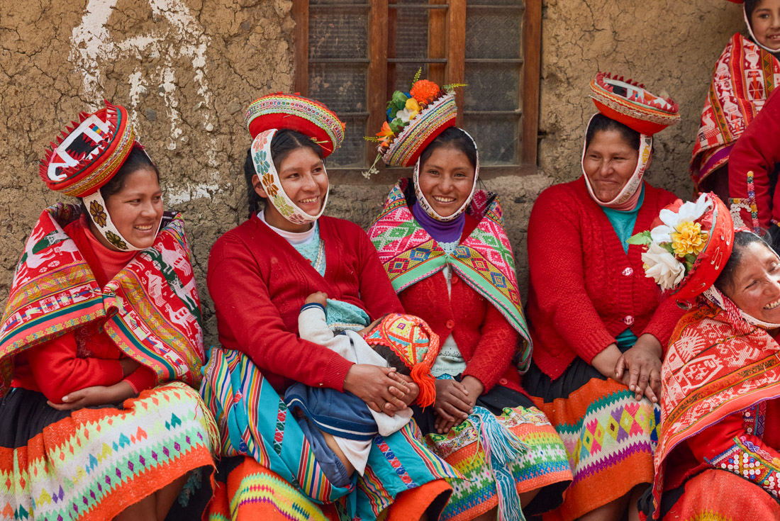 Women of the Sacred Valley Huilloc community in Peru smile and laugh together
