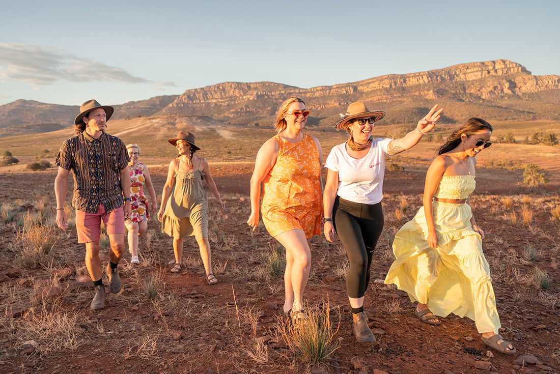 Group and leader walking at sunset in the Flinders Ranges, South Australia