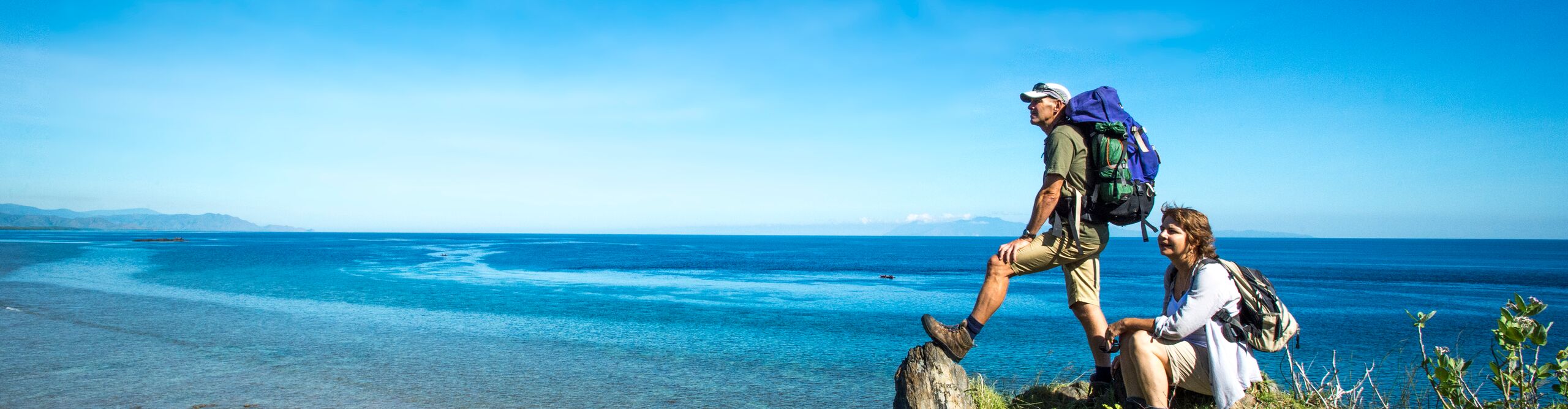 Two hikers pose with view of Dolok Oan Beach