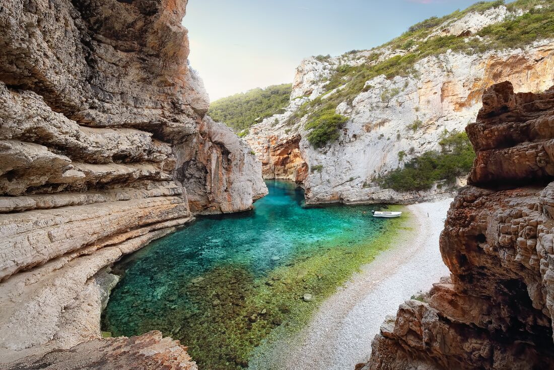 Secluded Stiniva Beach on Vis Island in an eroded stone harbour