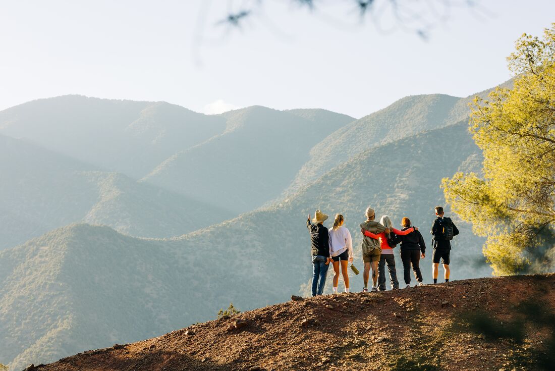 Intrepid travellers and leader take in the view of Atlas Mountains in Morocco