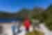 Travellers receive a talk from the leader on the shores of Dove Lake with Cradle Mountain looming behind
