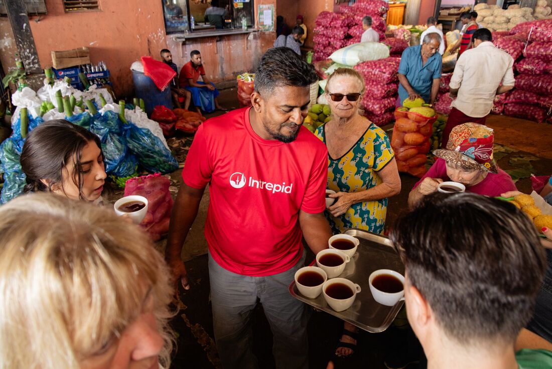 Leader sharing tea at the food market in Dambulla, Sri Lanka