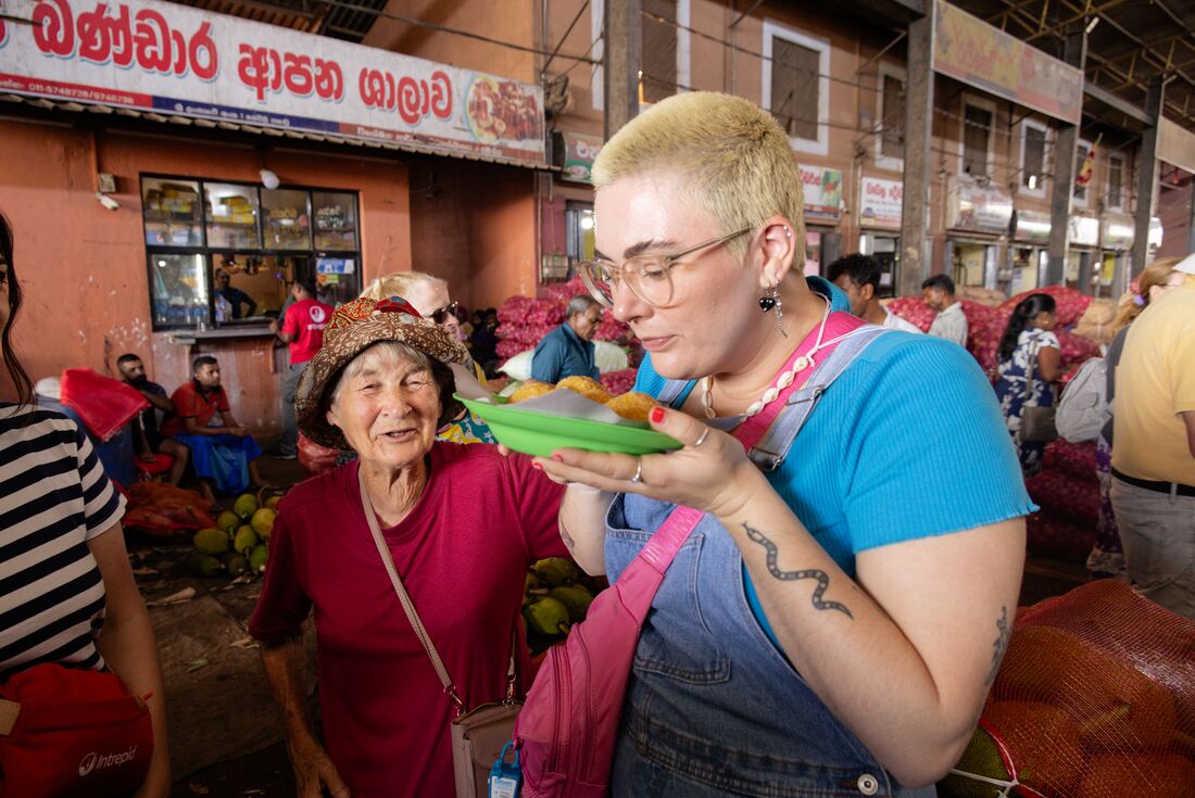 Traveller smelling food at food market in Dambulla, Sri Lanka