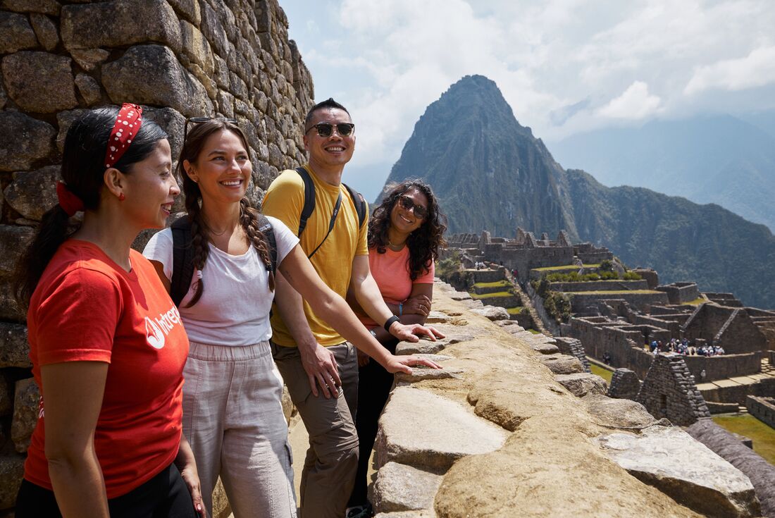Intrepid travellers finally relax after a long trek at Machu Picchu in Peru